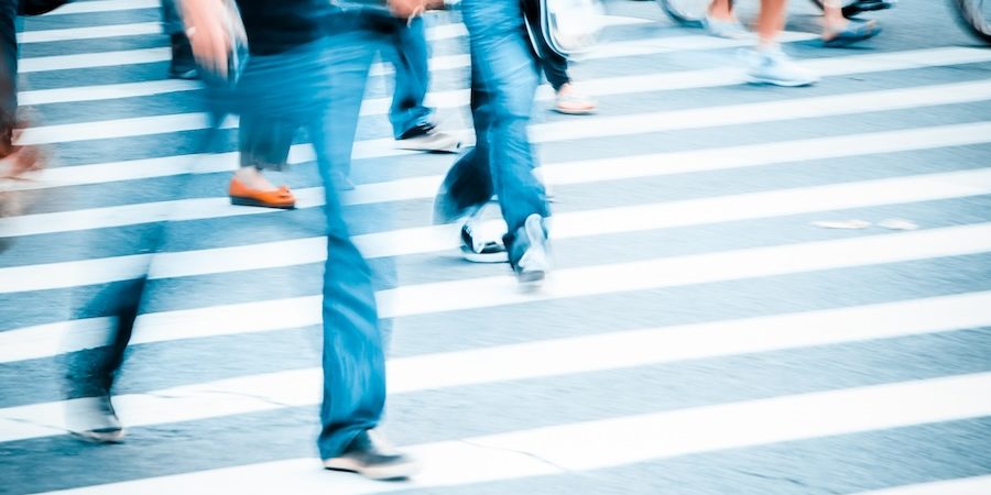 Pedestrians and bicyclists cross a busy intersection in New Jersey